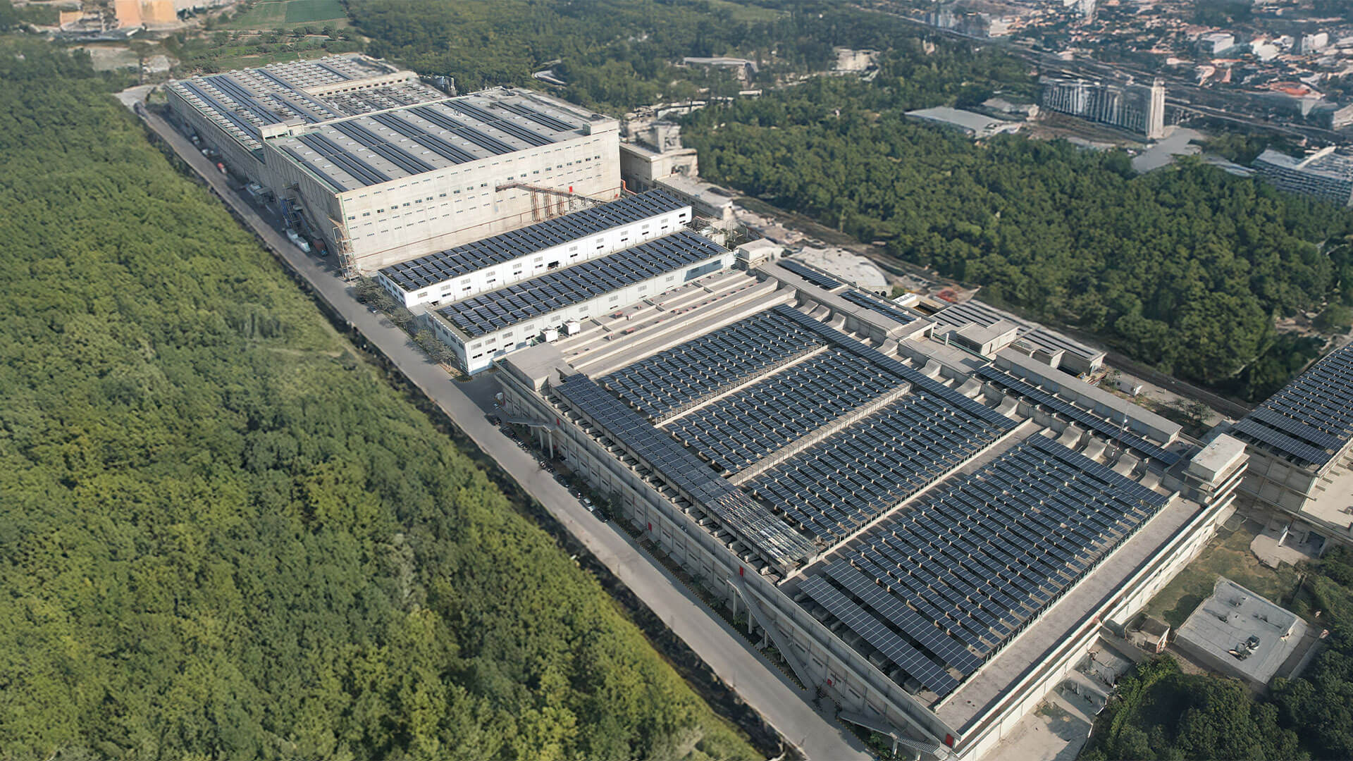 Aerial view of AGI Denim’s vertically integrated manufacturing facility surrounded by greenery in Pakistan.